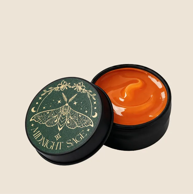 A tin of orange calendula salve with the midnight sage logo on the lid.