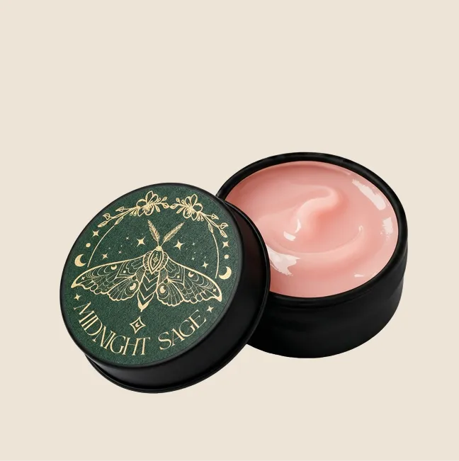 A tin of rose salve with the midnight sage logo on the lid.