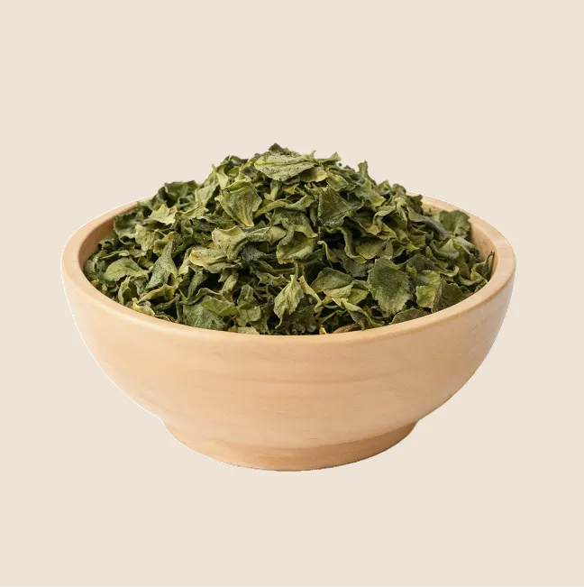 A wooden bowl filled with dried comfrey leaves.